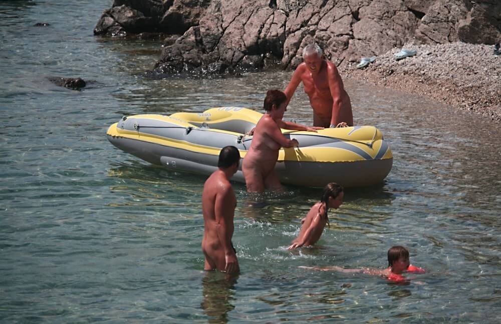 Lone Nudist in Yellow Boat photos - Naturism is connected to self-love and love of nature
