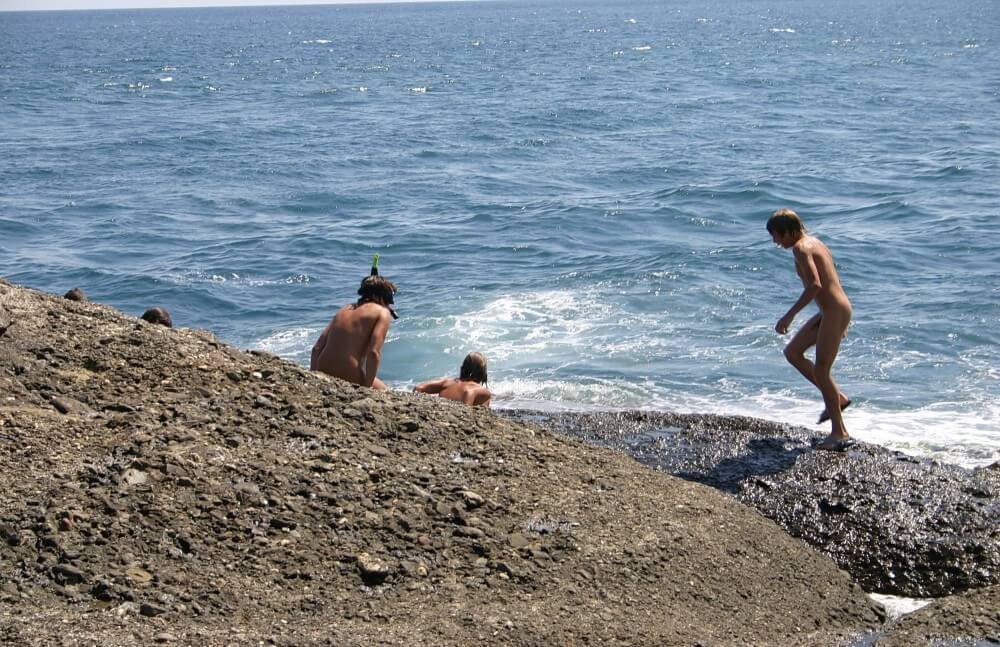 Leaning Against Hit Rocks pics - A basic understanding of naturism is necessary
